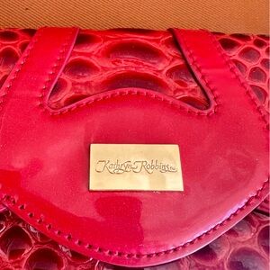 Katheryn Robbin’s red handbag / clutch..